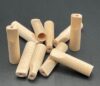 Wooden dowels scattered on a black surface.