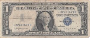 A collector examining PMG graded notes to buy and include in his collection.